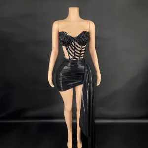 Conjunto de top corsé negro con pedrería y minifalda fruncida con drapeado lateral
