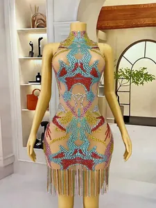 Detailed view of colorful rhinestone patterns and tassel hem on a bodycon mini dress.