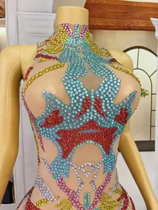 Detail of semi-high neck dress with colorful rhinestone patterns on mesh fabric