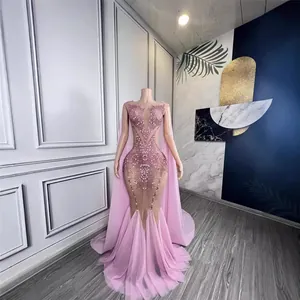 Elegant pink mermaid evening gown with deep V-neck and rhinestone detailing for red carpet.