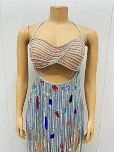 Detailed view of a sexy silver fringe halter dress with colorful rhinestones on a mannequin