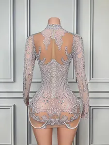 Detailed back view of a sheer mini dress with intricate rhinestone and pearl patterns