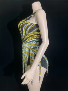 Side view of a sparkling gold and silver rhinestone mini dress on a display mannequin