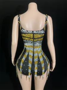 Detail view of black backless mini dress with gold and silver rhinestone stripes