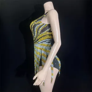 Sparkling yellow and silver rhinestone backless mini dress with tassels on mannequin