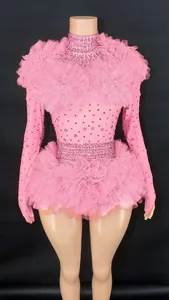 Detailed view of pink rhinestone bodysuit with ruffled tulle shoulders and waist.