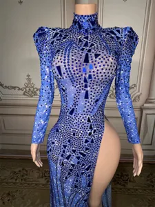 Close-up of sparkling blue rhinestone-encrusted evening gown with a high side slit