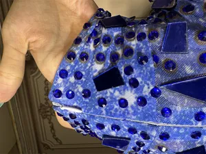 Close-up detail of blue rhinestones and sequins on a bodycon evening party dress