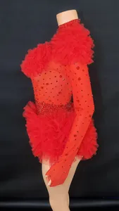 Detailed side view of a red rhinestone bodysuit featuring layered tulle ruffles and sequins