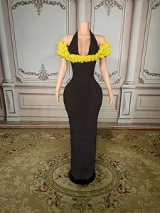 Elegant black halter neck evening gown featuring yellow floral off-the-shoulder details.