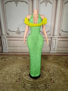 Elegant green rhinestone evening gown with yellow floral halter neck and slim fit.