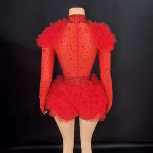 Red rhinestone bodysuit with ruffled shoulders and tutu shorts for stage performances.