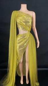 Detailed view of a gold one-shoulder sequin evening gown with high slit and cutout