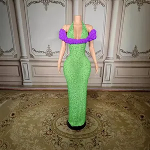 Elegant green sleeveless sparkling evening gown with purple floral off-shoulder detail