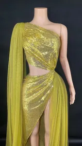 Elegant gold one-shoulder sequined evening gown featuring waist cutout and high slit.