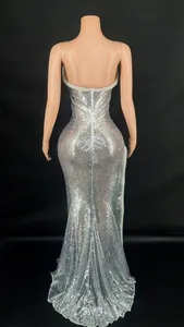 Close-up detail view of the elegant backless design on this silver sequined evening gown dress.