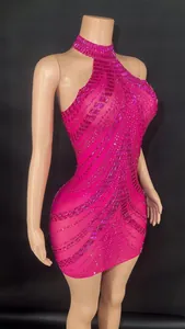 Detailed close-up of pink halter mini dress featuring intricate sparkling rhinestone pattern