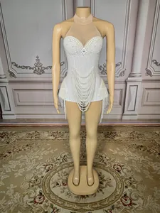 Full view showing intricate pearl beading and fringe detail on white stage bodysuit