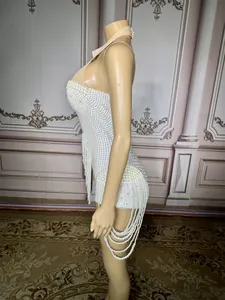 Side view detail of a white sexy pearl bodysuit with fringe for stage performance