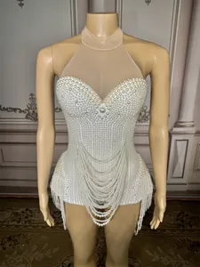 Close-up detail of sexy white pearl bodysuit with mesh neck and draped chains
