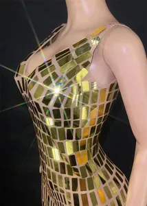 Detailed macro view of sparkling gold rectangular mirror sequins on a slim fit bodycon dress.