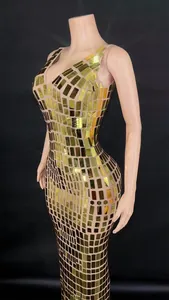 Detailed view of an elegant gold mirrored sequin evening dress on a mannequin base