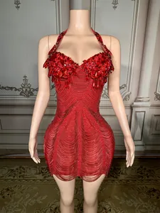 Close-up detail of a glamorous red halter mini dress with rhinestones and beaded fringe