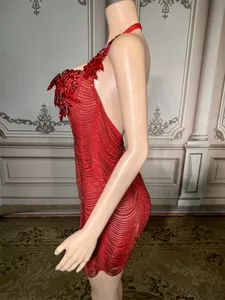 Side view detail of a red halter mini dress with crystal and beaded decorations