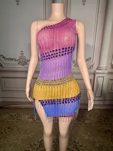 Detailed view of a colorful one-shoulder mini dress with heart sequins and tassels.