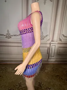 Side view of a sleeveless mini dress with colorful fringes and heart rhinestones.