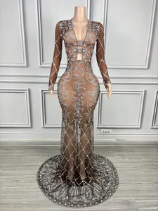 Intricate silver rhinestone pattern detail on sheer coffee-colored V-neck evening gown