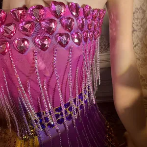 Glamorous purple bodycon mini dress featuring pink heart rhinestones and sparkly tassels