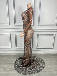 Side view of sheer brown rhinestone evening gown on a mannequin for detail display