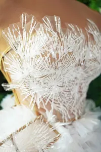 Vista dettagliata dell'intricato ricamo di paillettes bianche su questo elegante mini abito