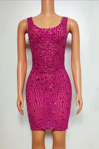 Close-up of fuchsia bodycon mini dress fully embellished with sparkling rhinestones