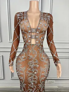 Detail view of rhinestone-embellished sheer mesh evening gown on mannequin