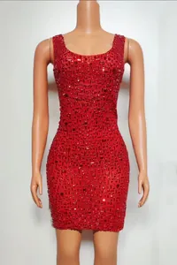 Front view detail of a red bodycon mini dress with intricate rhinestone beading