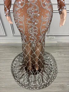 Close-up of brown mesh maxi dress with sparkling rhinestone swirling patterns