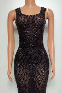 Detailed view of a sleeveless bodycon mini dress with black rhinestone embellishments