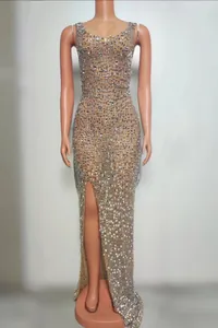 Full view of elegant nude floor-length evening dress with sparkling silver rhinestones and slit