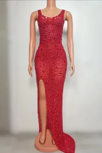Elegant red floor-length evening gown with shimmering sequins and a daring high thigh slit.