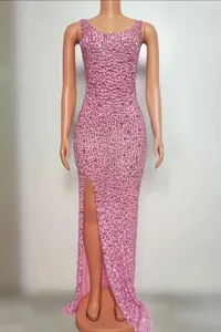 Detail view of pink sequined embroidery and high slit on this slim fit evening gown