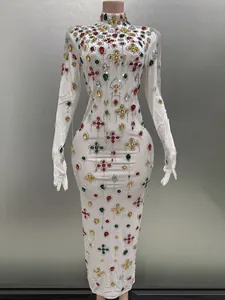 Detail of white bodycon dress with colorful rhinestone clovers and fringe gloves
