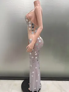 Detailed side view of sleeveless backless party dress with silver star sequins.