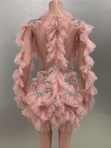Back view detail of pink mesh ruffled mini dress with silver rhinestone embellishments