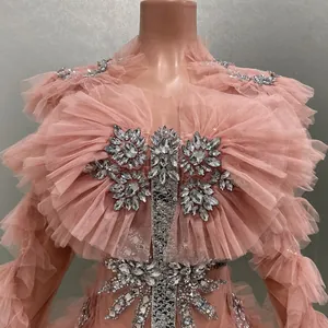 Close-up of pink mesh ruffled mini dress with intricate rhinestone embellishments