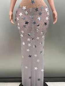Close-up of elegant purple mesh evening gown with silver star sequins and pearl details.