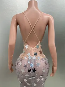 Close-up of backless bodycon dress with silver star sequins and cross-back straps