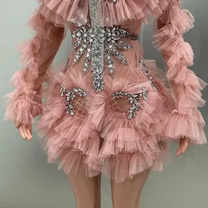 Close-up of pink ruffled mesh dress with silver rhinestone embellishments