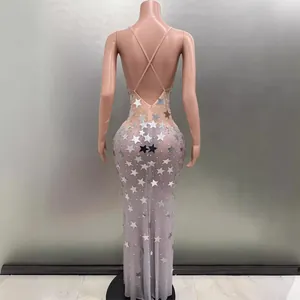 Backless nude evening gown featuring silver star sequins and cross-back straps